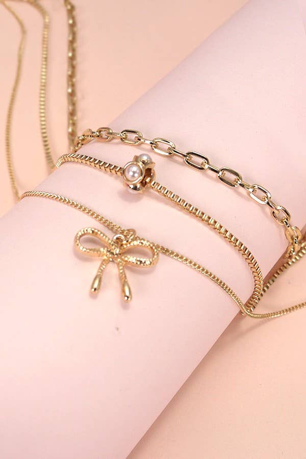 MULTI LAYER PEARL BOW CHARM NECKLACE | 80N605